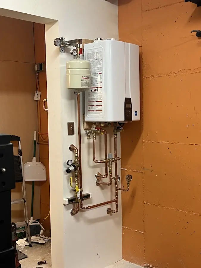 Plumbing technician inspecting water heater connections in Sarasota